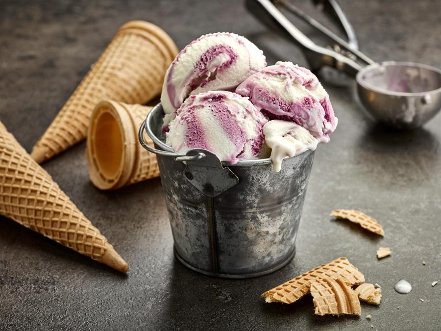 vanilla and blueberry ice cream on dark gray table